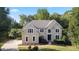 Charming two-story home with a well-manicured lawn and mature trees offers great curb appeal at 915 Summer Wind Pl, Roswell, GA 30075