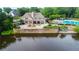 View of clubhouse from across the lake, next to community pool and outdoor seating at 915 Summer Wind Pl, Roswell, GA 30075