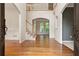 Welcoming foyer with hardwood floors, staircase, arched doorways, and a view to the living room at 915 Summer Wind Pl, Roswell, GA 30075