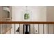 Grand foyer showcasing a striking chandelier, arched doorway, and wood railing at 915 Summer Wind Pl, Roswell, GA 30075