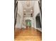 Bright and airy foyer with hardwood floors, high ceilings, elegant light fixture, and an open staircase at 915 Summer Wind Pl, Roswell, GA 30075