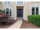 Elegant front entrance featuring a double door entry, stone walkway, and landscaped garden beds at 915 Summer Wind Pl, Roswell, GA 30075