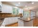 Bright kitchen with granite counters, white cabinets, tile backsplash, and hardwood flooring at 915 Summer Wind Pl, Roswell, GA 30075