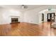 Spacious living room featuring fireplace, hardwood floors, staircase and arched doorway at 915 Summer Wind Pl, Roswell, GA 30075