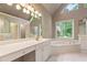 Spacious main bathroom with a soaking tub, double vanities and natural light at 915 Summer Wind Pl, Roswell, GA 30075