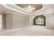 Large main bedroom with tray ceiling, carpet and several large windows at 915 Summer Wind Pl, Roswell, GA 30075