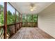 Screened porch features natural views, wooden railing and a ceiling fan at 915 Summer Wind Pl, Roswell, GA 30075