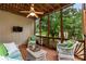 Spacious screened porch with ceiling fan and comfortable seating area at 915 Summer Wind Pl, Roswell, GA 30075