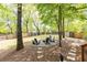 Spacious backyard features mature trees, grassy lawn, and a gravel seating area at 3110 Dickson Ne St, Brookhaven, GA 30319