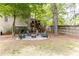 Backyard view with outdoor seating around a fire pit and deck with covered porch above at 3110 Dickson Ne St, Brookhaven, GA 30319