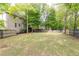 Spacious, green backyard with privacy fence and partial view of the home's exterior at 3110 Dickson Ne St, Brookhaven, GA 30319