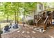 Beautiful backyard with mature trees, elevated deck, and gravel firepit area at 3110 Dickson Ne St, Brookhaven, GA 30319