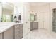 Bright bathroom featuring a double sink vanity, a large framed mirror and a glass enclosed shower at 3110 Dickson Ne St, Brookhaven, GA 30319