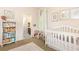 Charming Bedroom with white crib, bookshelf, and soft pink accents for a cozy and inviting space at 3110 Dickson Ne St, Brookhaven, GA 30319