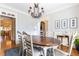 Charming dining room with a rustic chandelier, hardwood floors, and bright, neutral paint at 3110 Dickson Ne St, Brookhaven, GA 30319