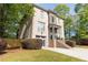 Beautiful brick home featuring a two-car garage, stone accents, manicured lawn, and attractive landscaping at 3110 Dickson Ne St, Brookhaven, GA 30319