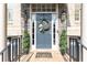 Charming front door with brick surround, stylish wreath, decorative sidelights and manicured landscaping at 3110 Dickson Ne St, Brookhaven, GA 30319