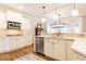 Well-lit kitchen with white cabinets, stainless steel appliances, and hardwood floors at 3110 Dickson Ne St, Brookhaven, GA 30319