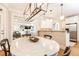 Eat-in kitchen with stylish lighting and seamless flow to living area at 3110 Dickson Ne St, Brookhaven, GA 30319