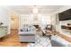 Bright living room with coffered ceilings, a fireplace, hardwood floors and custom built-ins at 3110 Dickson Ne St, Brookhaven, GA 30319