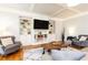 Comfortable living room with coffered ceilings, custom built-ins, and hardwood floors at 3110 Dickson Ne St, Brookhaven, GA 30319