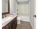 Neutral full bathroom with shower-tub, undermount sink and dark wood vanity at 5211 Benjamin Trl, Ellenwood, GA 30294
