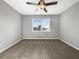 Clean, carpeted bedroom with a large window and ceiling fan at 5211 Benjamin Trl, Ellenwood, GA 30294