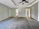 Spacious main bedroom features a ceiling fan, carpet, and multiple doors at 5211 Benjamin Trl, Ellenwood, GA 30294
