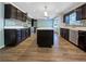 Modern kitchen with dark cabinets, stainless steel appliances, and a center island at 5211 Benjamin Trl, Ellenwood, GA 30294
