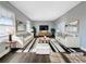 Bright and airy living room with white sofas, striped rug, and modern decor at 5211 Benjamin Trl, Ellenwood, GA 30294