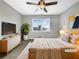 Cozy primary bedroom with a ceiling fan, a dresser, and a large window at 5211 Benjamin Trl, Ellenwood, GA 30294