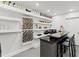 Finished basement featuring a modern bar with floating shelves at 8610 Sentinae Chase Dr, Roswell, GA 30076