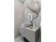 Stylish bathroom with unique mirror, modern vanity, and gray tile walls at 8610 Sentinae Chase Dr, Roswell, GA 30076