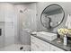 Modern bathroom featuring gray tile, white cabinets, and a glass shower enclosure at 8610 Sentinae Chase Dr, Roswell, GA 30076