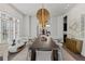 Stylish dining room features a large table, modern lighting, and bright white decor, perfect for entertaining at 8610 Sentinae Chase Dr, Roswell, GA 30076