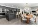 A modern open concept featuring kitchen, dining room with chandelier, and chairs surrounding the round table at 8610 Sentinae Chase Dr, Roswell, GA 30076