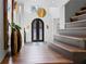 Grand entryway featuring high ceilings, a custom iron door, and decorative vases offers a luxurious welcome at 8610 Sentinae Chase Dr, Roswell, GA 30076