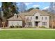 Elegant two-story home with a manicured lawn and beautiful landscaping provides a picturesque setting at 8610 Sentinae Chase Dr, Roswell, GA 30076