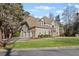 Beautiful two-story house with a three-car garage, set amidst a well-maintained lawn and mature trees at 8610 Sentinae Chase Dr, Roswell, GA 30076