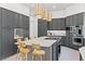 Modern kitchen with a large island, stainless steel appliances, and elegant gray cabinetry at 8610 Sentinae Chase Dr, Roswell, GA 30076