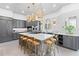 Spacious kitchen featuring a center island with seating, stainless steel appliances, and modern gray cabinets at 8610 Sentinae Chase Dr, Roswell, GA 30076