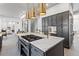 Sleek kitchen island featuring cooktop, stainless steel appliances, and modern fixtures at 8610 Sentinae Chase Dr, Roswell, GA 30076