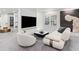 Modern living room with a large TV screen, couch and artwork at 8610 Sentinae Chase Dr, Roswell, GA 30076