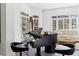 Sunlit living room featuring a grand piano, artful decor, and plush seating is perfect for relaxation at 8610 Sentinae Chase Dr, Roswell, GA 30076