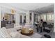 Spacious living room with piano, multiple seating areas, and modern decor offers luxury living and room to entertain at 8610 Sentinae Chase Dr, Roswell, GA 30076