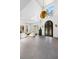 Bright living room featuring high ceilings, modern lighting, and a decorative iron door at 8610 Sentinae Chase Dr, Roswell, GA 30076
