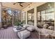 Stylish screened porch with comfortable seating and views of the surrounding nature at 8610 Sentinae Chase Dr, Roswell, GA 30076