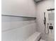 Modern shower with sleek gray tiles, a built-in bench, and contemporary fixtures at 8610 Sentinae Chase Dr, Roswell, GA 30076