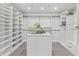 Spacious walk-in closet featuring custom shelving, storage, and a stylish center island at 8610 Sentinae Chase Dr, Roswell, GA 30076