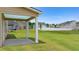 Expansive backyard featuring a covered patio, lush green grass, and privacy fence at 13562 Whitman Ln, Covington, GA 30014
